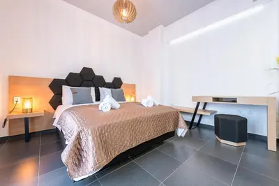 a bedroom with a large bed and a television at Acropolis foothill in Athens