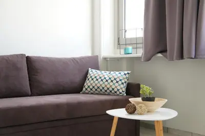 a living room with a couch and a table at A&I Apartments & Studios in Athens