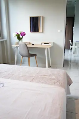 a bedroom with a desk and a chair and a bed at A&I Apartments & Studios in Athens
