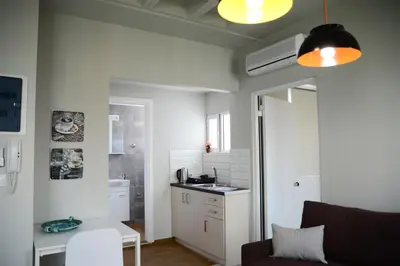 a living room with a couch and a kitchen at A&I Apartments & Studios in Athens