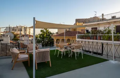a patio with a table and chairs on a balcony at Live Life Plaka Apartment in Athens