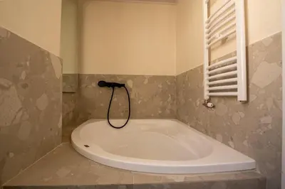 a bath tub in a bathroom with a window at Live Life Plaka Apartment in Athens