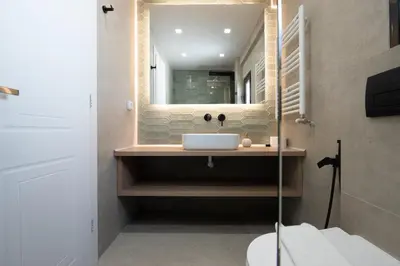 a bathroom with a sink and a mirror at Live Life Plaka Apartment in Athens