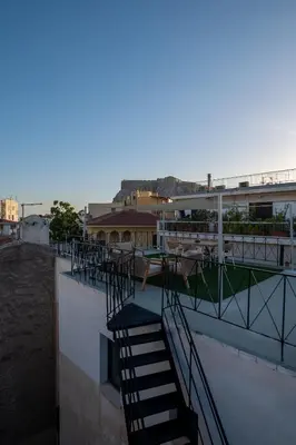 a balcony with stairs on the side of a building at Live Life Plaka Apartment in Athens
