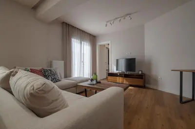 a living room with a couch and a tv at Live Life Plaka Apartment in Athens