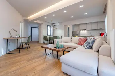 a living room with a couch and a table at Live Life Plaka Apartment in Athens