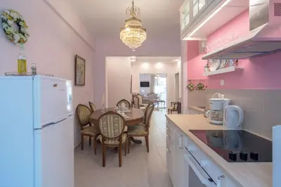 a kitchen and dining room with a table and a refrigerator at Lovely Apartment in Athens in Athens