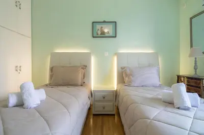 two beds sitting next to each other in a room at Lovely Apartment in Athens in Athens