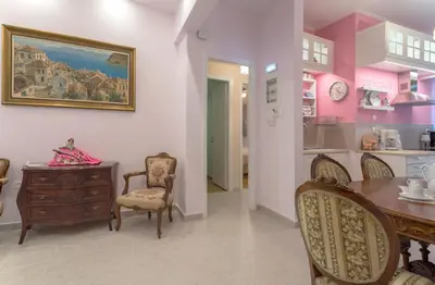 a dining room with a table and chairs and a kitchen at Lovely Apartment in Athens in Athens