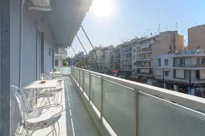 a balcony with a table and chairs on a building at Lovely Apartment in Athens in Athens