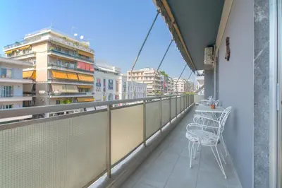 a balcony with a table and chairs on a building at Lovely Apartment in Athens in Athens