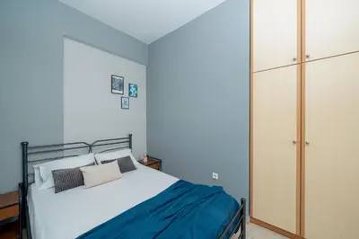 a bedroom with a bed and a closet at A&D Apartments in Porto Rafti
