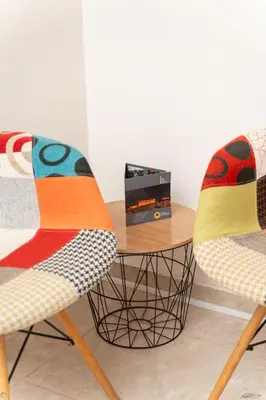 a table with two chairs and a box on it at A&D Apartments in Porto Rafti