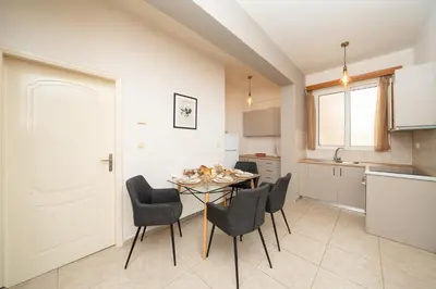 a kitchen and dining room with a table and chairs at A&D Apartments in Porto Rafti