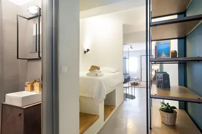 a bedroom with a bed and a sink and a mirror at Soho Apartments by Olala Homes in Athens