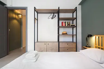 a bedroom with a bed with two towels on it at Soho Apartments by Olala Homes in Athens