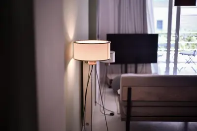 a lamp in a room with a couch and a television at Soho Apartments by Olala Homes in Athens