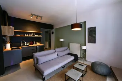 a living room with a couch and a kitchen at Soho Apartments by Olala Homes in Athens