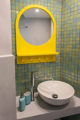 a bathroom with a sink and a yellow mirror at Acropolis Monastiraki Newly Renovated Apartment in Athens