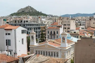 a view of a city with buildings and a mountain at Acropolis Monastiraki Newly Renovated Apartment in Athens