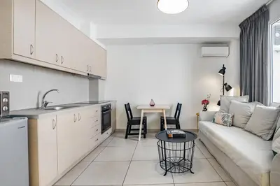 a kitchen and a living room with a couch and a table at Supreme C1 Apartment in Syntagma in Athens