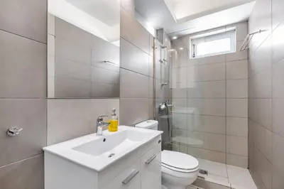 a bathroom with a white sink and a toilet at Supreme C1 Apartment in Syntagma in Athens