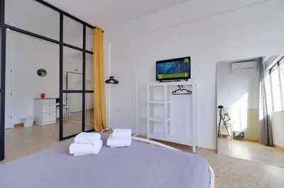 a bedroom with a bed with two white towels at athens.apartotel.1 in Athens