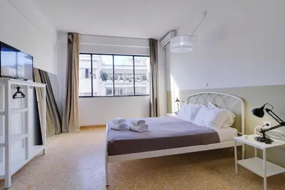 a bedroom with a bed and a large window at athens.apartotel.1 in Athens