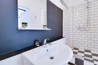 a bathroom with a white sink and a mirror at athens.apartotel.1 in Athens