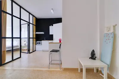 a kitchen with a table and a chair in a room at athens.apartotel.1 in Athens