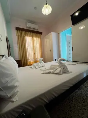 a large bed with white towels on top of it at Finikas Rooms in Agia Marina Aegina