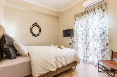 a bedroom with a bed and a window at Iris apartment acropolis terrace view in Athens