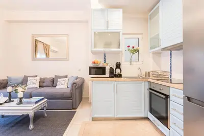 a kitchen and living room with a couch and a table at Iris apartment acropolis terrace view in Athens