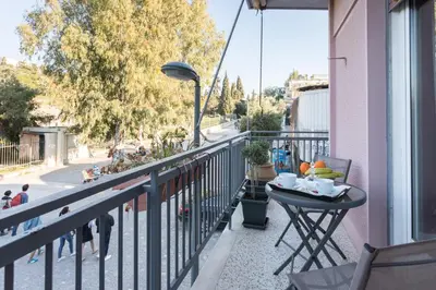 a balcony with a table with a bowl of fruit on it at Iris apartment acropolis terrace view in Athens