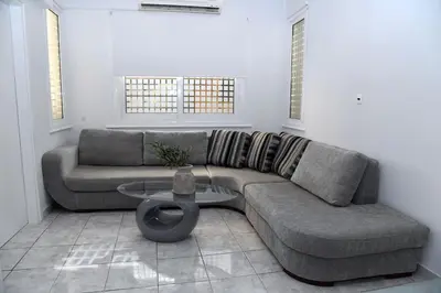 a living room with a couch and a table at Best of Athens Apartment in Athens