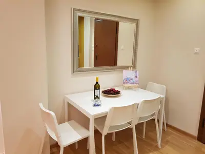 a dining room with a white table and a mirror at Stylish Urban Apartment by YHA in Athens