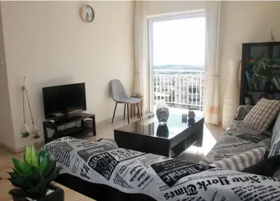 a living room with a couch and a tv at Penthouse with Sea View in Athens