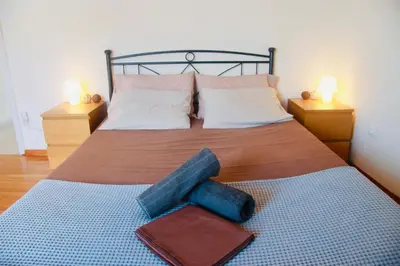 a bedroom with a bed with two pillows on it at Penthouse with Sea View in Athens