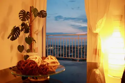 a plate of food on a table in front of a window at Penthouse with Sea View in Athens