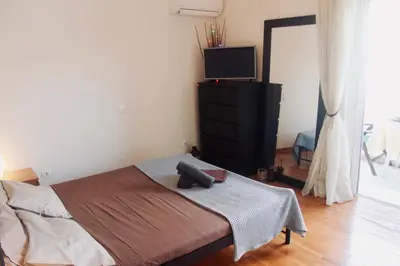 a bedroom with a bed with a tv on it at Penthouse with Sea View in Athens