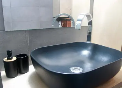 a black sink with a faucet in a bathroom at Penthouse with Sea View in Athens