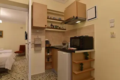a small kitchen with a sink and a microwave in a room at Acro&Polis in Athens
