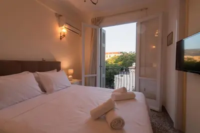 a bedroom with a bed with two towels on it at Acro&Polis in Athens