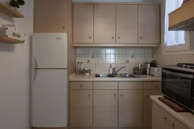 a kitchen with a white refrigerator and a sink at Acro&Polis in Athens