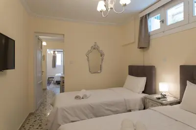 a hotel room with two beds and a mirror at Acro&Polis in Athens