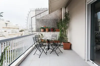 a patio with a table and chairs on a balcony at Athens Vintage Apartment - Ilisia in Athens