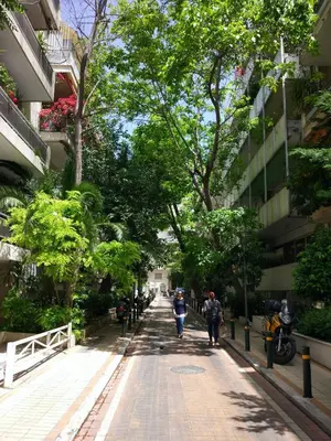 a city street with people walking down a sidewalk at Athens Vintage Apartment - Ilisia in Athens