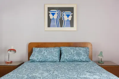 a bedroom with a bed and a picture on the wall at Athens Vintage Apartment - Ilisia in Athens