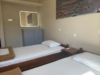 a room with two beds and a mirror at Paloma in Athens