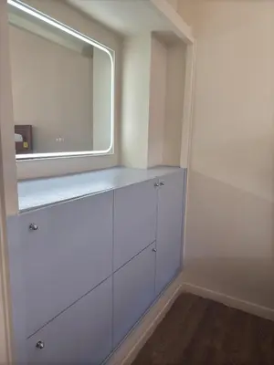 a dressing room with white cabinets and a mirror at Paloma in Athens